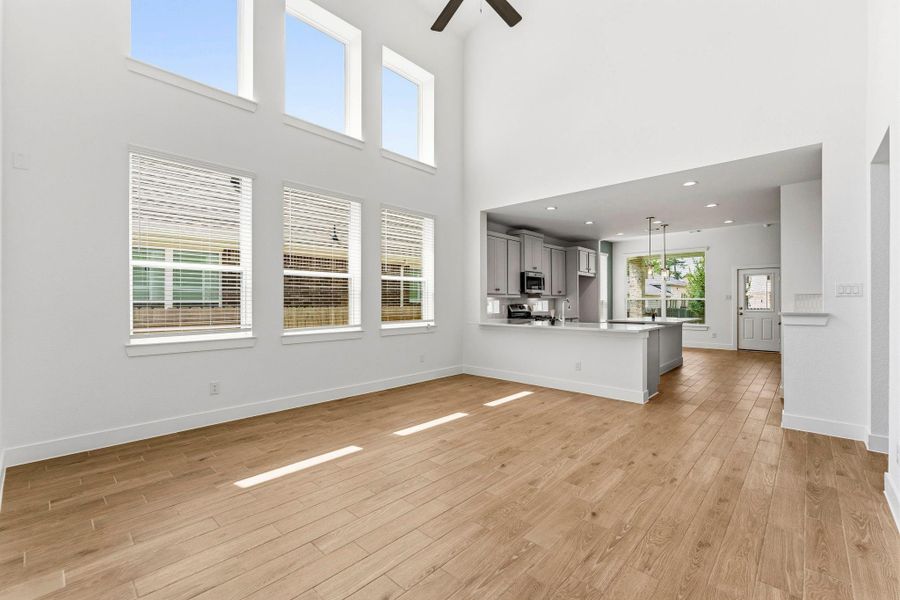 Wall of windows and 2-story ceiling in this spacious living room