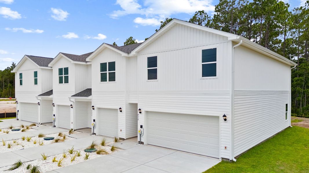 Front exterior of a new home in Chateau Nemours, Port Saint Joe, FL, highlighting curb appeal (Image 2). Front exterior of a new home in Chateau Nemours, Port Saint Joe, FL, highlighting curb appeal (Image 2).