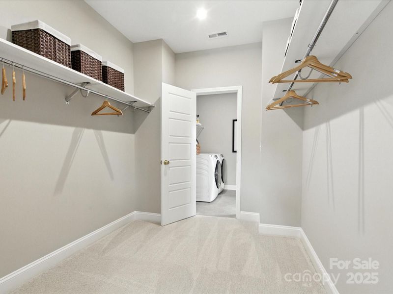 Huge primary walk-in closet leading to laundry room. *Model Photos | Orientation and structural selections may vary. Huge primary walk-in closet leading to laundry room. *Model Photos | Orientation and structural selections may vary.
