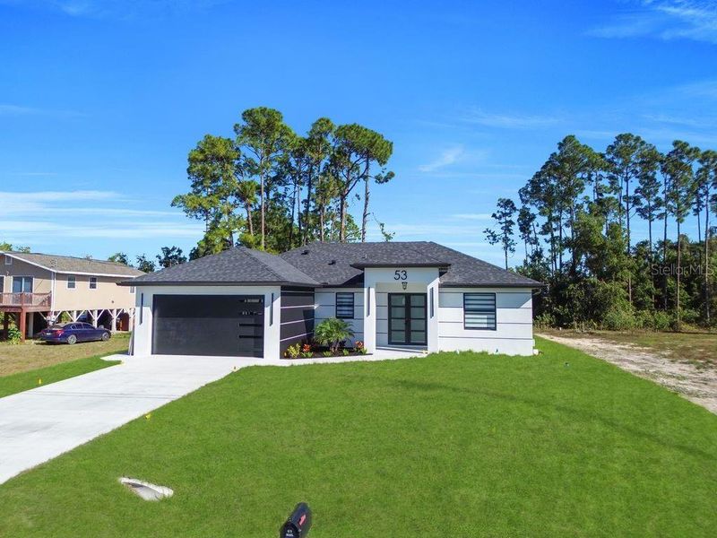 Front exterior of a new home in , Lehigh Acres, FL, highlighting curb appeal (Image 19).
