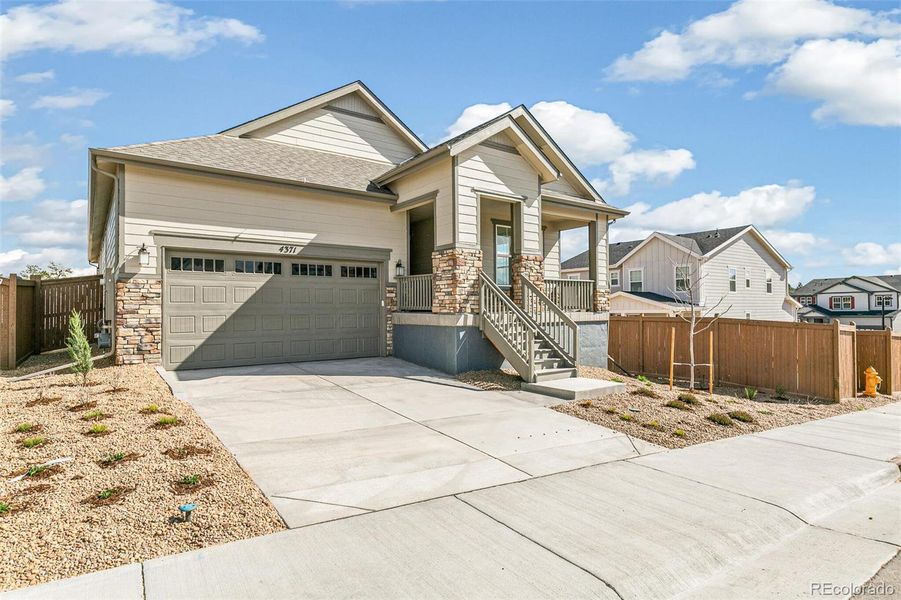 Front exterior of a new home in Terrain Oak Valley, Castle Rock, CO, highlighting curb appeal (Image 21).