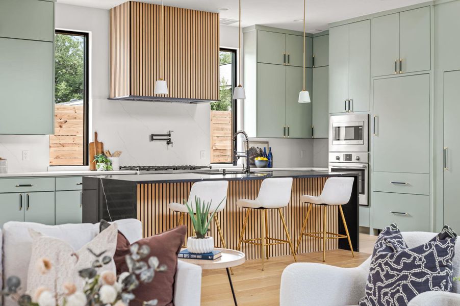A contemporary kitchen features sleek cabinetry and an inviting island with bar seating, perfect for casual dining. A contemporary kitchen features sleek cabinetry and an inviting island with bar seating, perfect for casual dining.