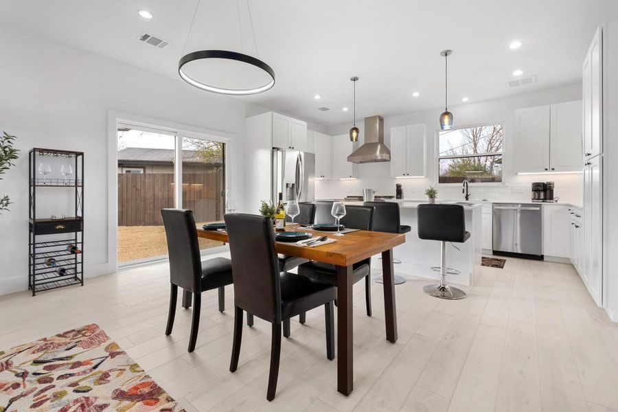 Dining room featuring healthy amount of natural light, light wood-style floors, and recessed lighting