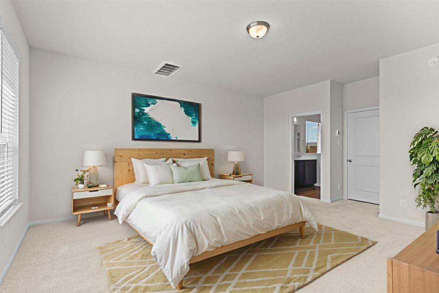Another view of the spacious primary suite showcasing the generous layout and relaxing atmosphere. The room offers plenty of space for a king size bed and additional furnishings while the soft carpeting adds comfort and warmth. **Virtually Staged**