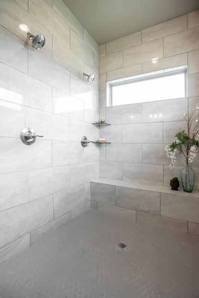 Full bath featuring a tile shower