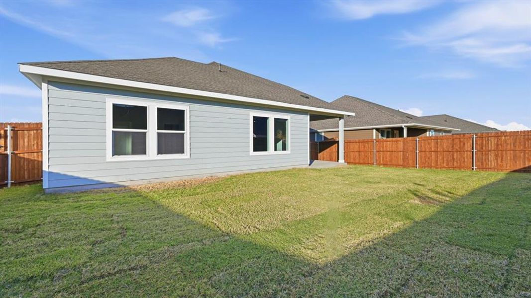 Rear view of property featuring a patio, a shingled roof, and a fenced backyard Rear view of property featuring a patio, a shingled roof, and a fenced backyard