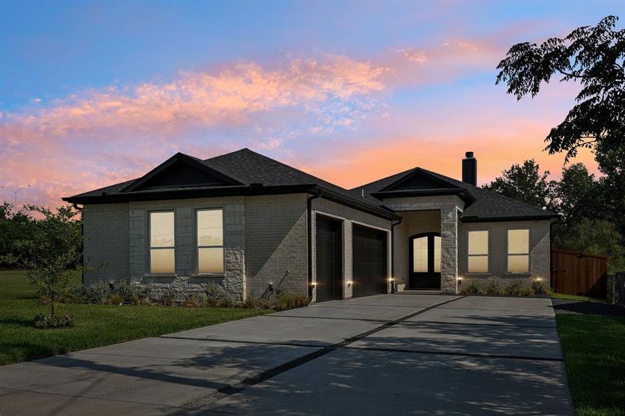 View of front of property featuring a garage and a lawn