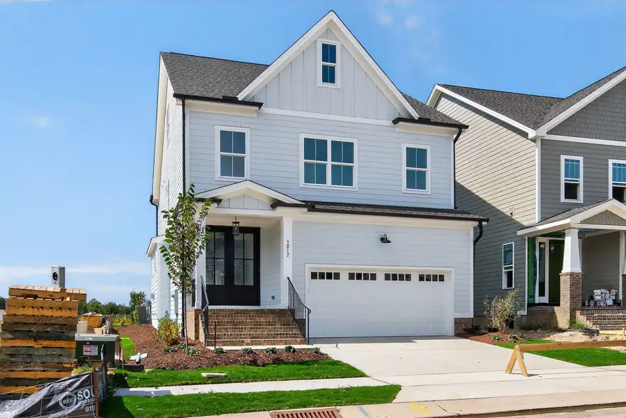 Front exterior of a new home in Wendell Falls, Wendell, NC, highlighting curb appeal (Image 2). Front exterior of a new home in Wendell Falls, Wendell, NC, highlighting curb appeal (Image 2).