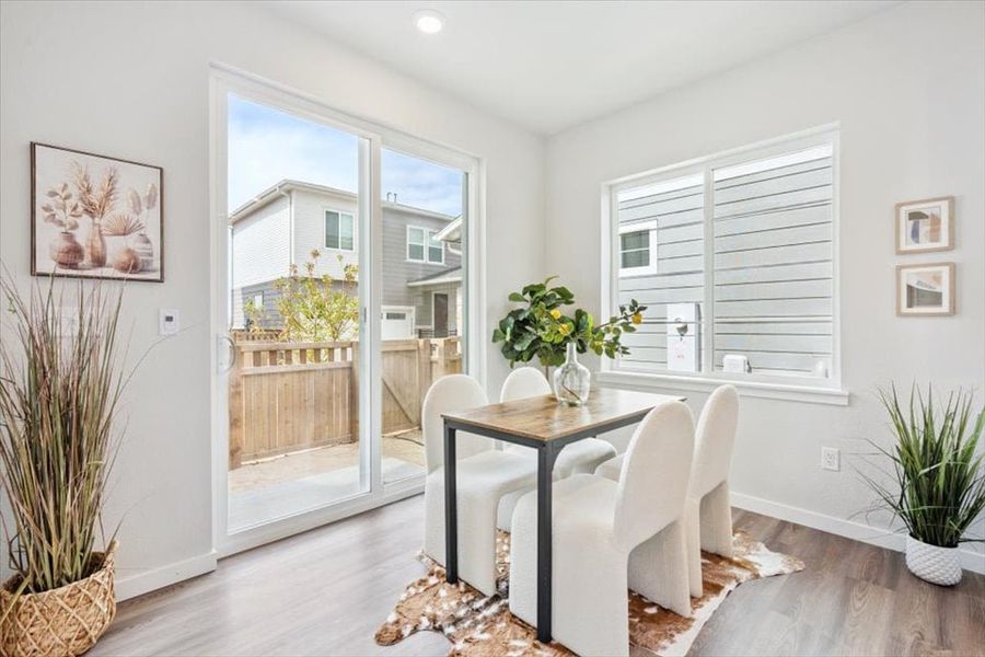 A dining room with a table and chairs. A dining room with a table and chairs.