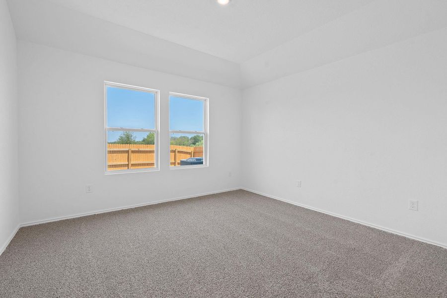 Carpeted spare room featuring baseboards Carpeted spare room featuring baseboards