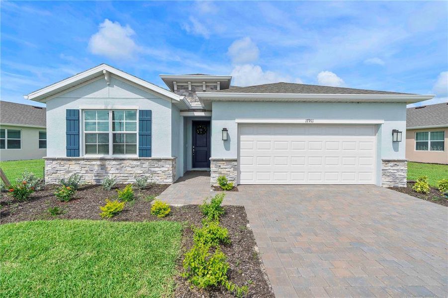 Front exterior of a new home in Palmetto Landing at Babcock Ranch - Tradition, Punta Gorda, FL, highlighting curb appeal (Image 23).