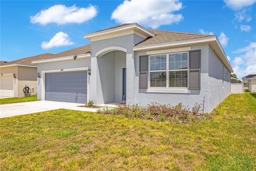 Front exterior of a new home in Cypress Park Estates, Haines City, FL, highlighting curb appeal (Image 23).