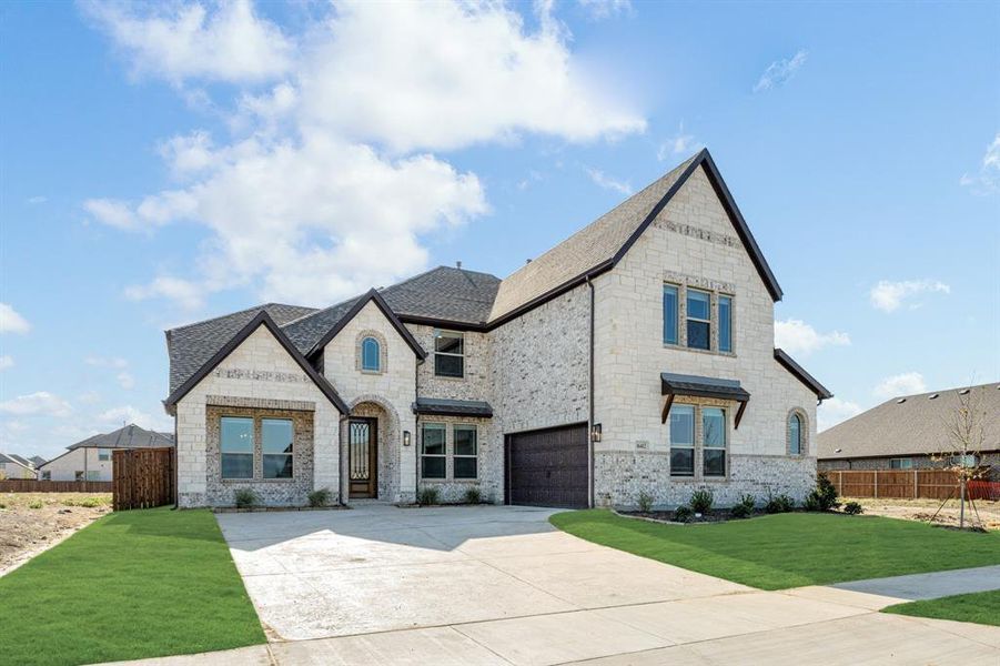 Front exterior of a new home in Wildflower Ranch 60-65, Justin, TX, highlighting curb appeal (Image 24). Front exterior of a new home in Wildflower Ranch 60-65, Justin, TX, highlighting curb appeal (Image 24).