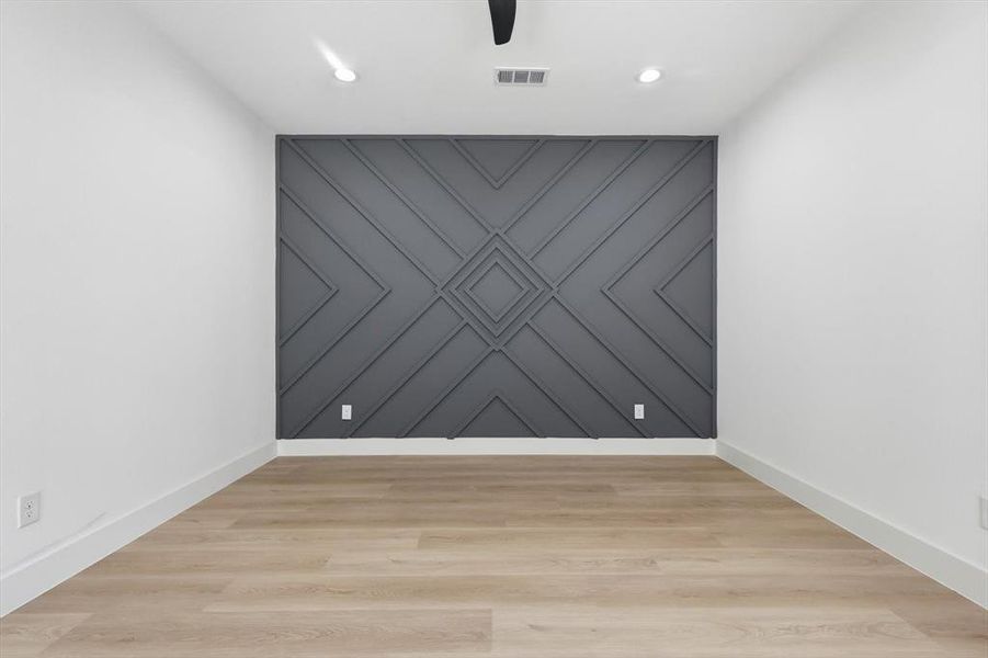 Spare room featuring an accent wall, light wood-type flooring, recessed lighting, and a ceiling fan
