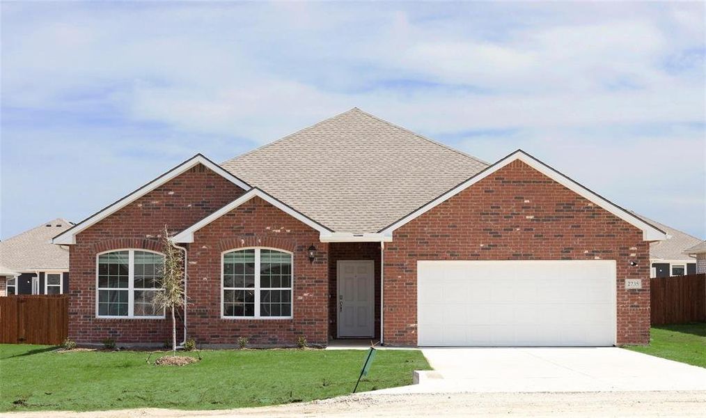 View of front of house with a garage and a front lawn