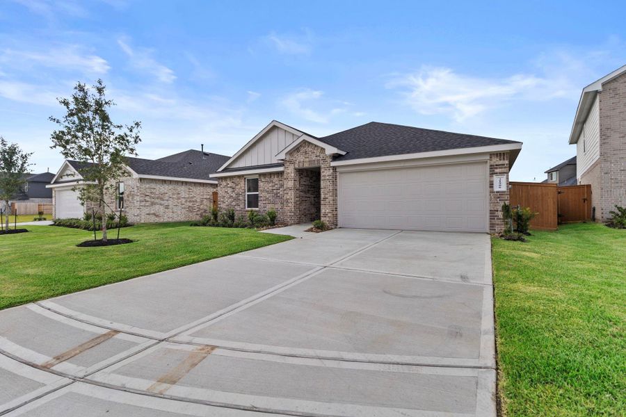 Front exterior of a new home in Cypress Green, Hockley, TX, highlighting curb appeal (Image 1). Front exterior of a new home in Cypress Green, Hockley, TX, highlighting curb appeal (Image 1).