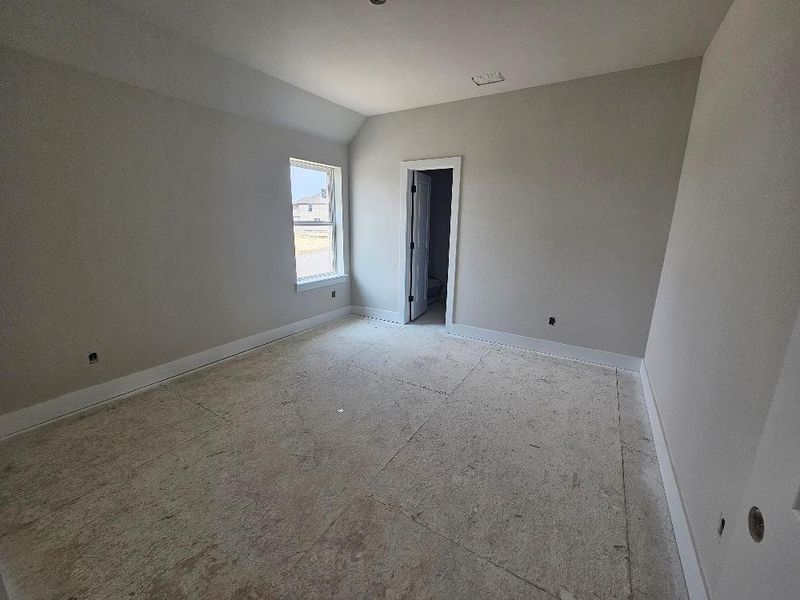 Empty room with baseboards and vaulted ceiling Empty room with baseboards and vaulted ceiling