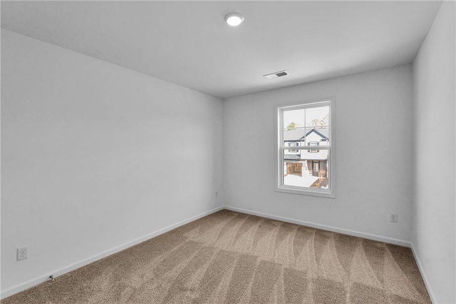 This bright room features soft carpeting and a win This bright room features soft carpeting and a win