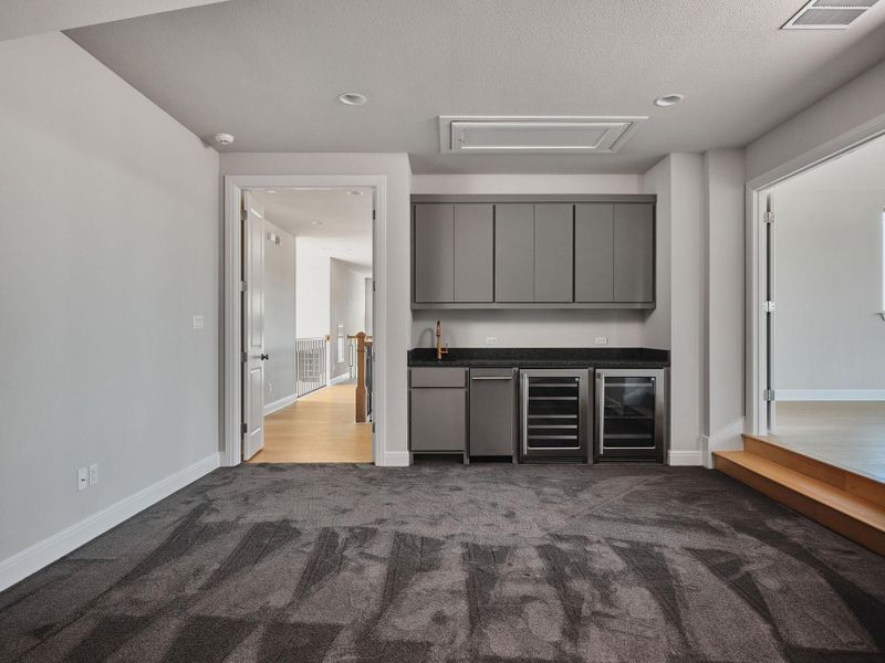 Upstairs offers exceptional entertaining space with a media room featuring a wet bar.