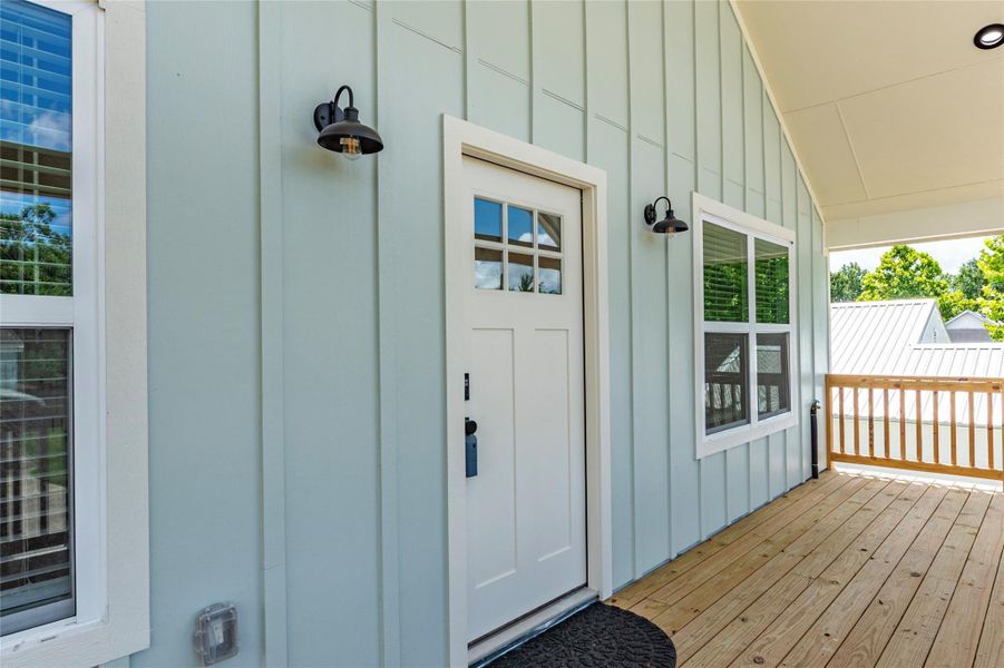 Exterior cement board siding with exterior outlets, recessed canned light and exterior coach light fixtures.