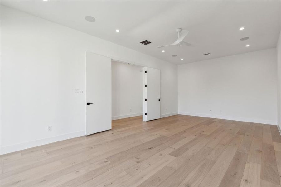 Unfurnished room featuring ceiling fan and light hardwood / wood-style flooring