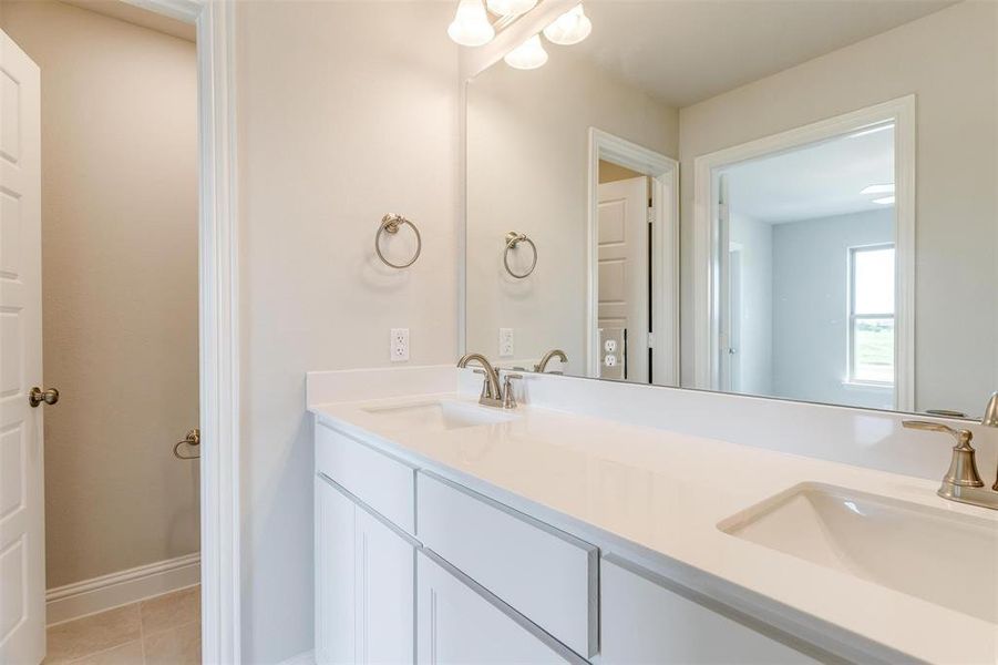 Bathroom featuring vanity and tile patterned flooring