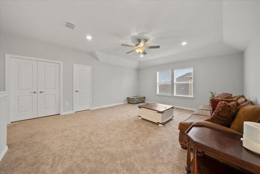 Loft/Game Room with closet, light colored carpet and ceiling fan.