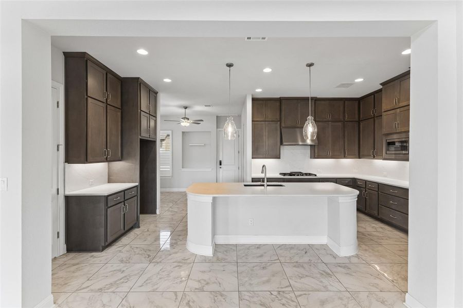 Culinary excellence awaits in this well-appointed kitchen with an elegant island and ample storage.