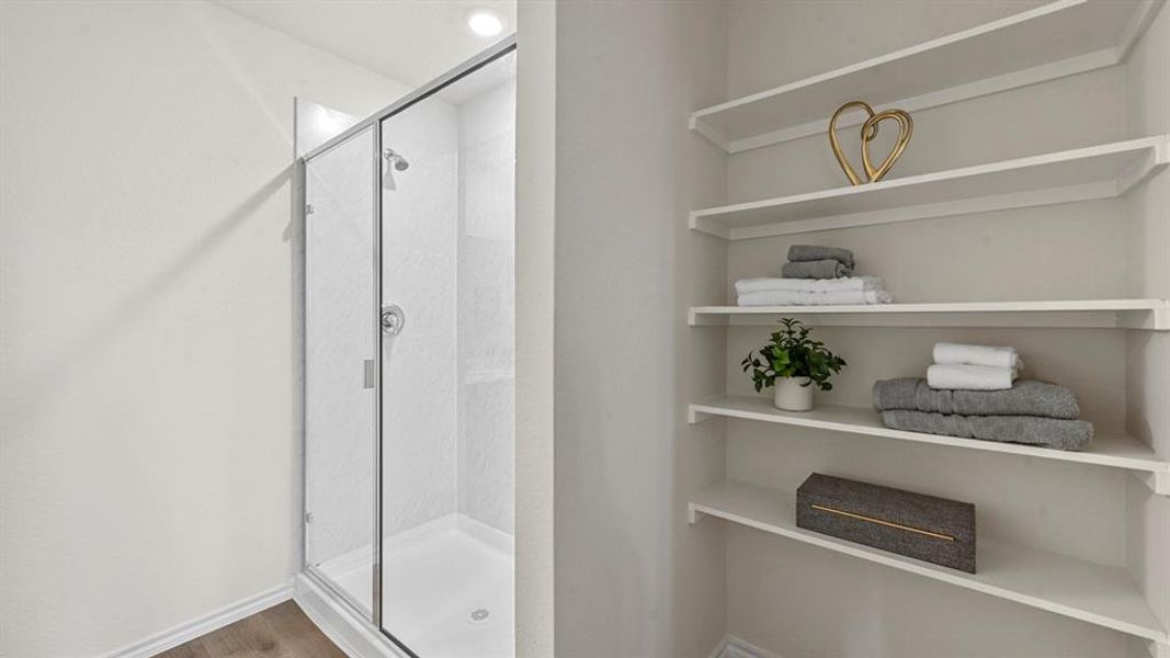 Full bath with a stall shower and wood finished floors Full bath with a stall shower and wood finished floors