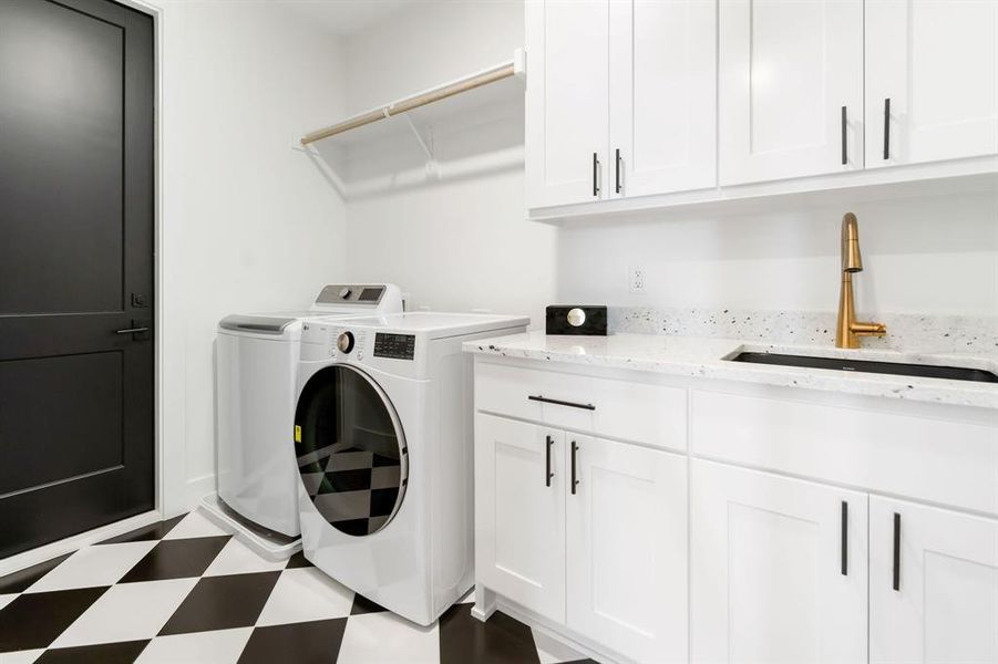 Upstairs Laundry area featuring dark flooring, washing machine and clothes dryer, and cabinet space Upstairs Laundry area featuring dark flooring, washing machine and clothes dryer, and cabinet space