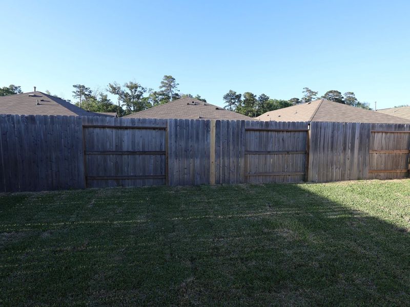 Exterior details and patio area of a home in Pinewood at Grand Texas, New Caney (Image 17).