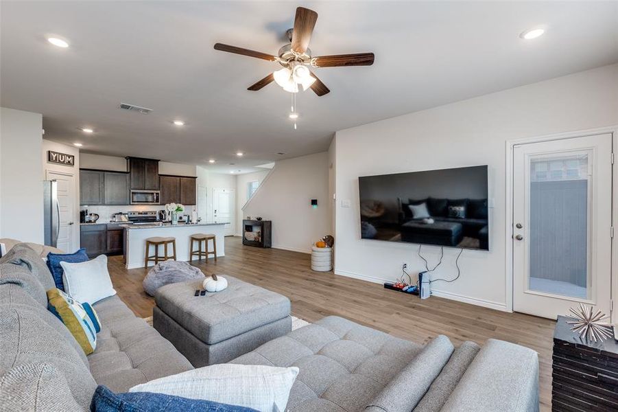 Living room with recessed lighting, a ceiling fan, and light wood finished floors Living room with recessed lighting, a ceiling fan, and light wood finished floors