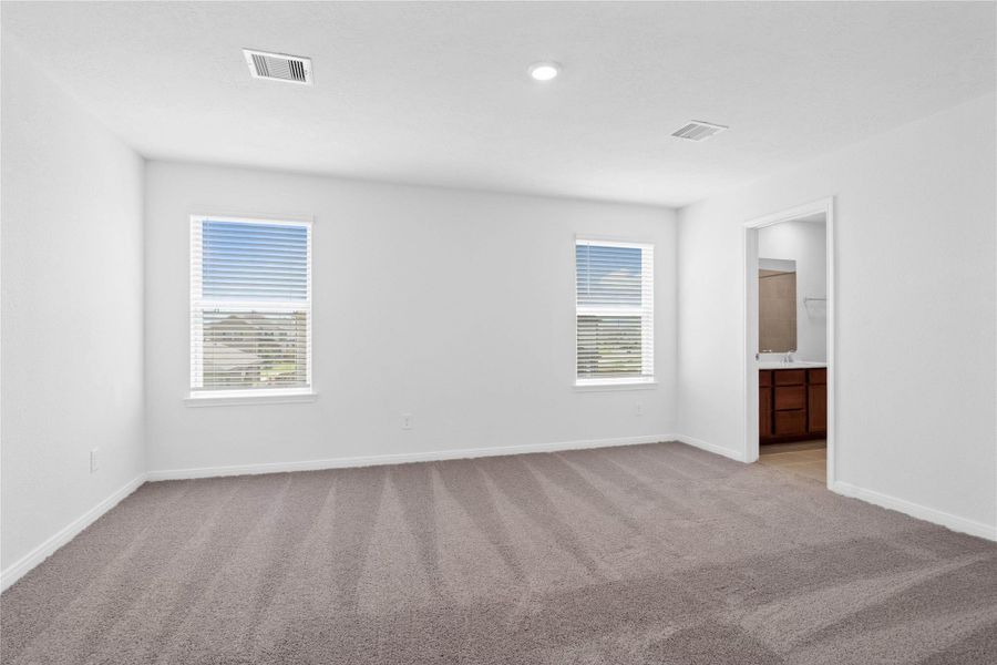 Relax and recharge in this stunning primary suite! This expansive room offers plush carpeting, custom nuetral walls, high ceilings, and large windows fitted with privacy blinds—perfect for unwinding after a long day. Relax and recharge in this stunning primary suite! This expansive room offers plush carpeting, custom nuetral walls, high ceilings, and large windows fitted with privacy blinds—perfect for unwinding after a long day.