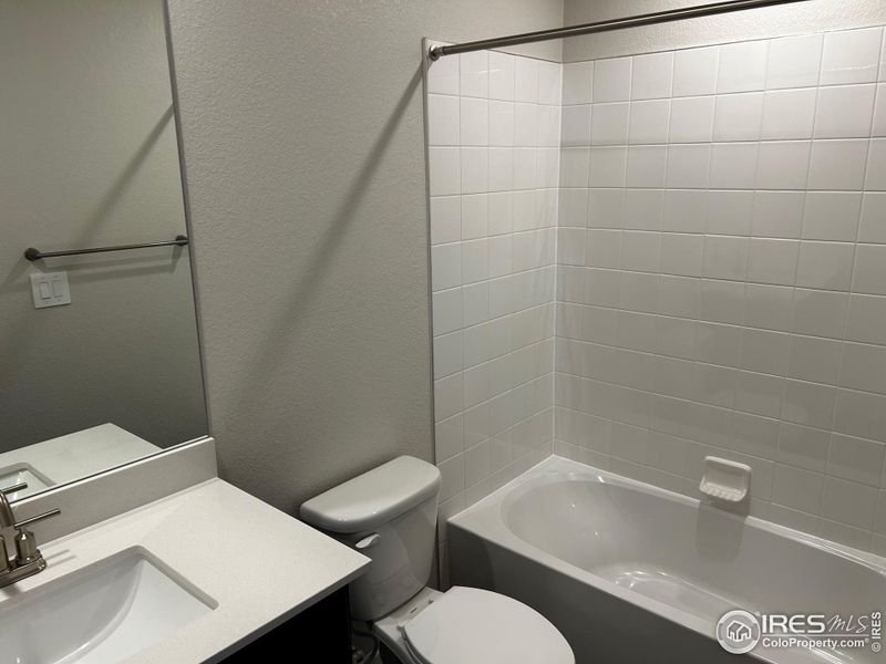 Upstairs full bathroom with quartz vanity and undermounted sink.