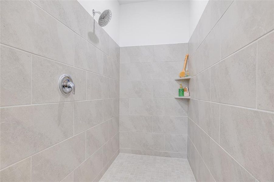 Full bathroom featuring tiled shower