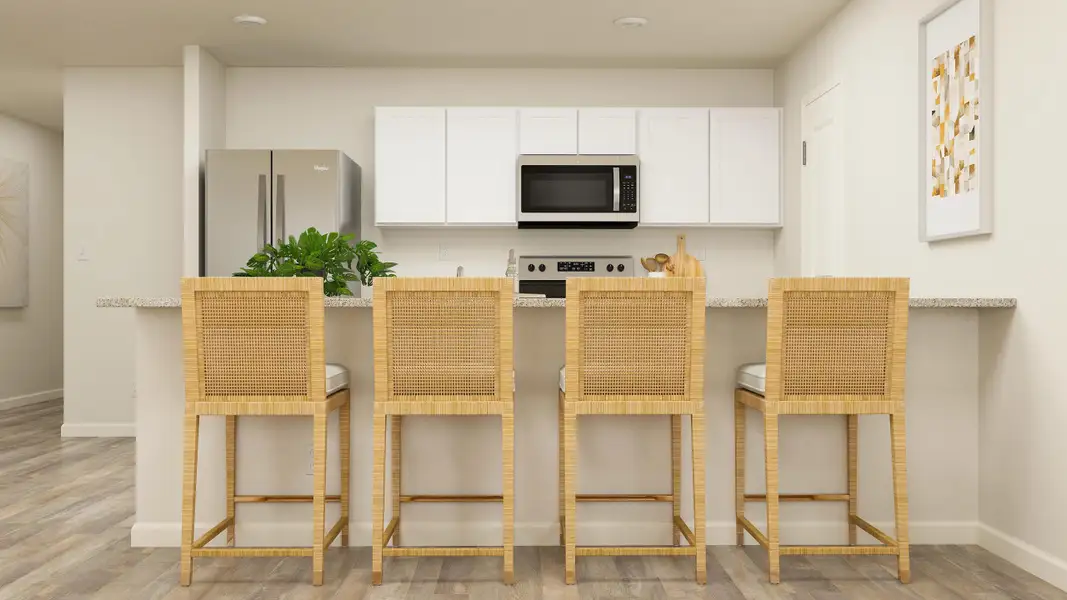 A kitchen with white cabinets.