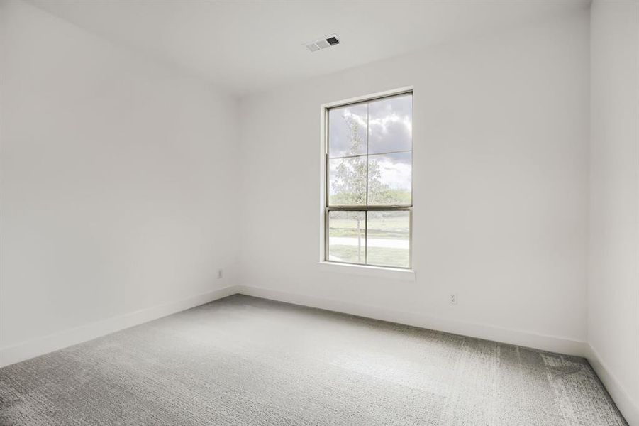 Empty room featuring carpet and baseboards