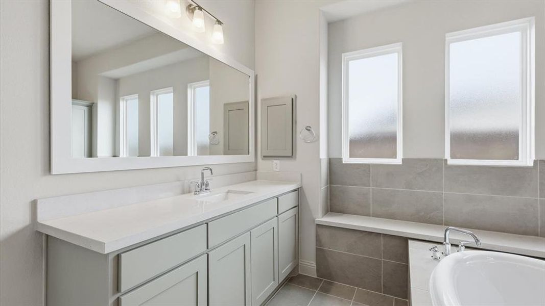 Dual-sink vanity with light-colored cabinetry and solid surface countertop