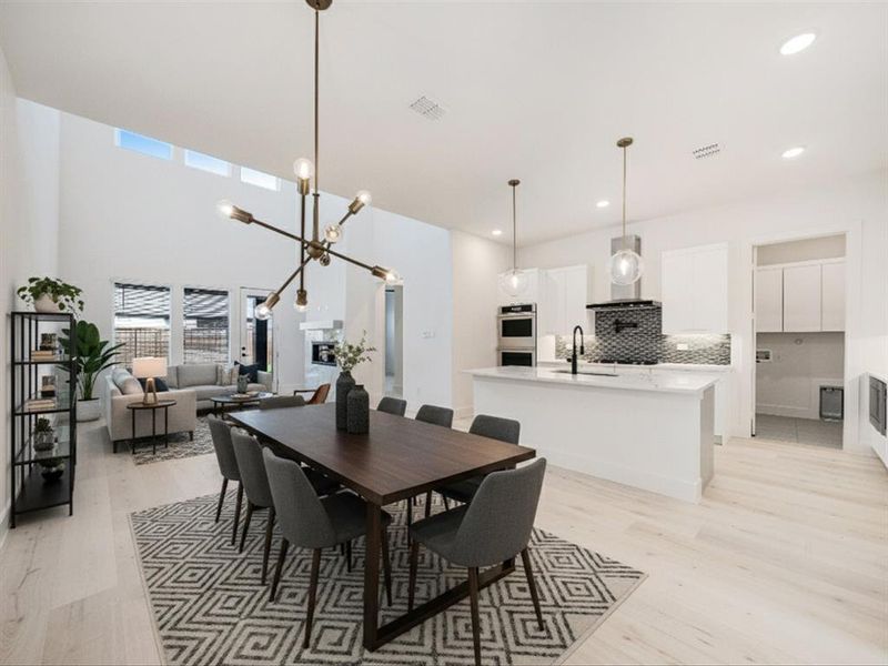 Dining space featuring light wood-style flooring, a chandelier, recessed lighting, and heating unit