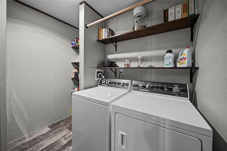 Laundry room featuring dark wood finished floors and independent washer and dryer Laundry room featuring dark wood finished floors and independent washer and dryer