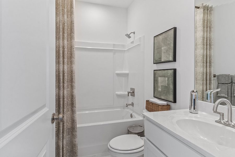 A bathroom with a tub sink and toilet.