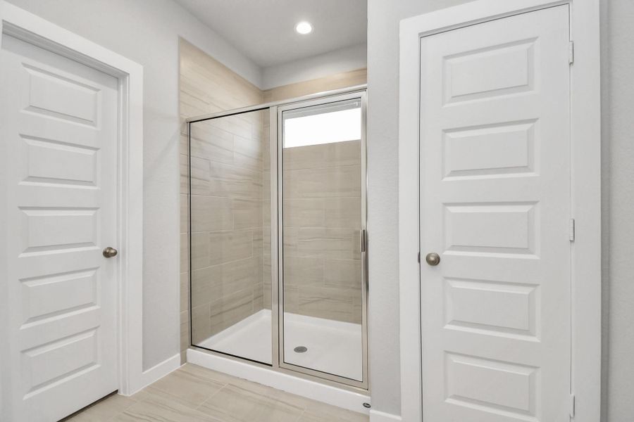 Escape to a spa-like oasis in this primary bathroom. Enjoy a walk-in showerwith tile surround! Sample photo of completed home with similar floor plan. Actual colors and selections may vary.