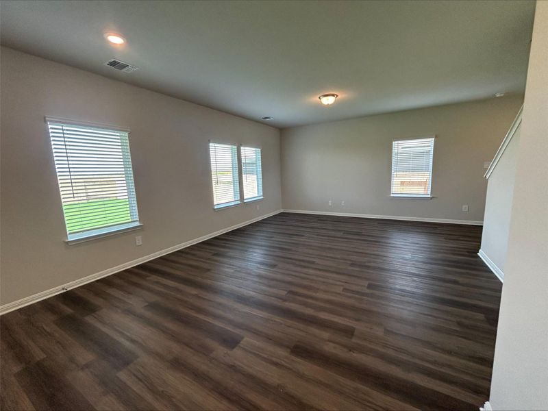 Empty room featuring baseboards and dark wood-style flooring Empty room featuring baseboards and dark wood-style flooring
