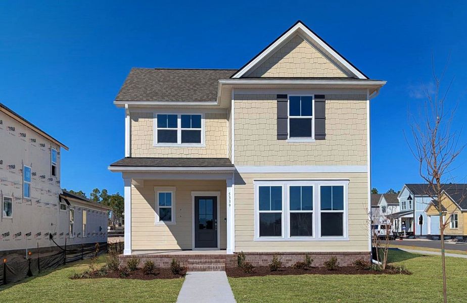 Front exterior of a new home in Riverlights, Wilmington, NC, highlighting curb appeal (Image 1). Front exterior of a new home in Riverlights, Wilmington, NC, highlighting curb appeal (Image 1).