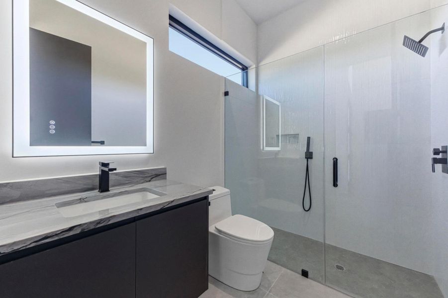 Full bath with a stall shower and vanity