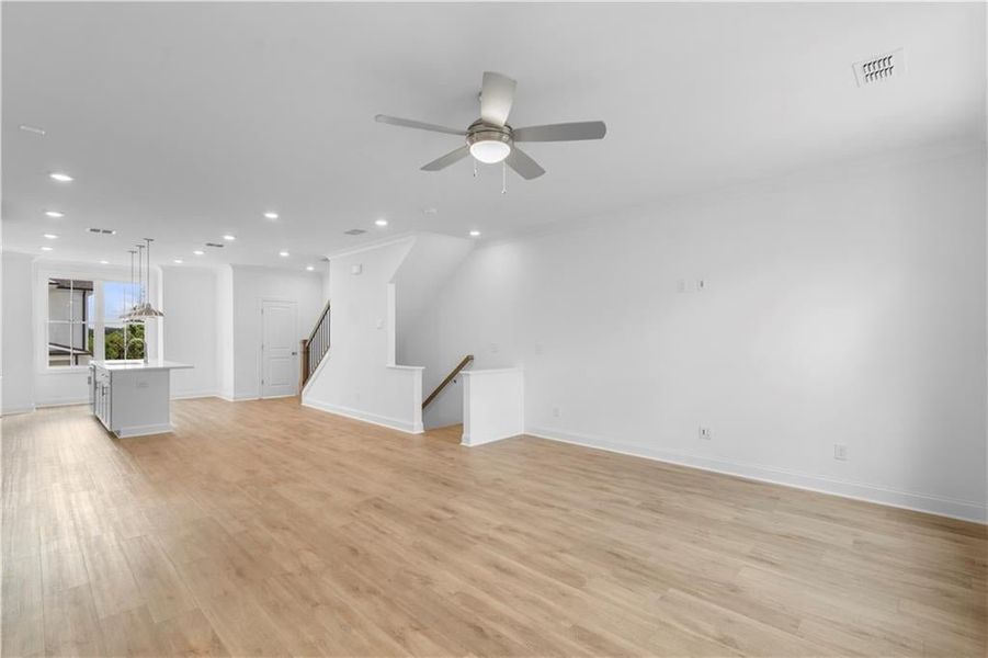 crown molding, ceiling fan in the family room - all open here - *Pictures represent a previously built home, not the actual home, home is under construction*