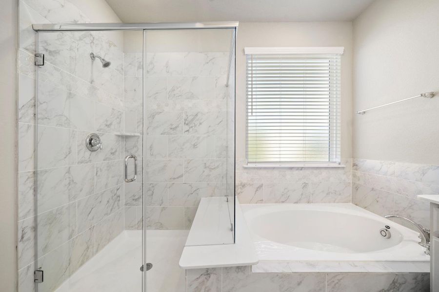 An en-suite bathroom features modern fixtures and a spa-like feel, providing a luxurious escape.