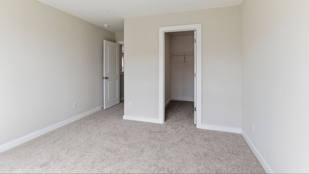 Bedroom with carpet and closet