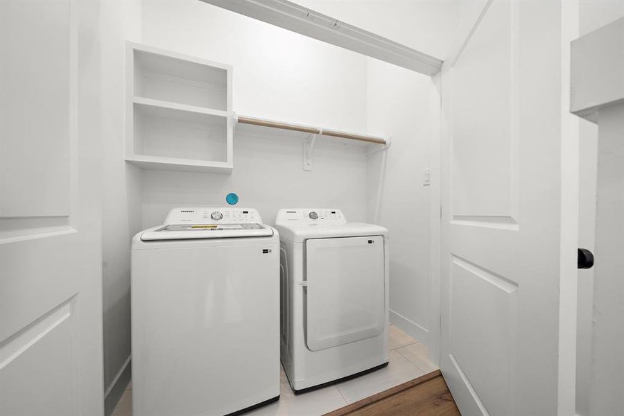 Clean and efficient utility room with modern washer and dryer, ample shelving, and convenient storage solutions.