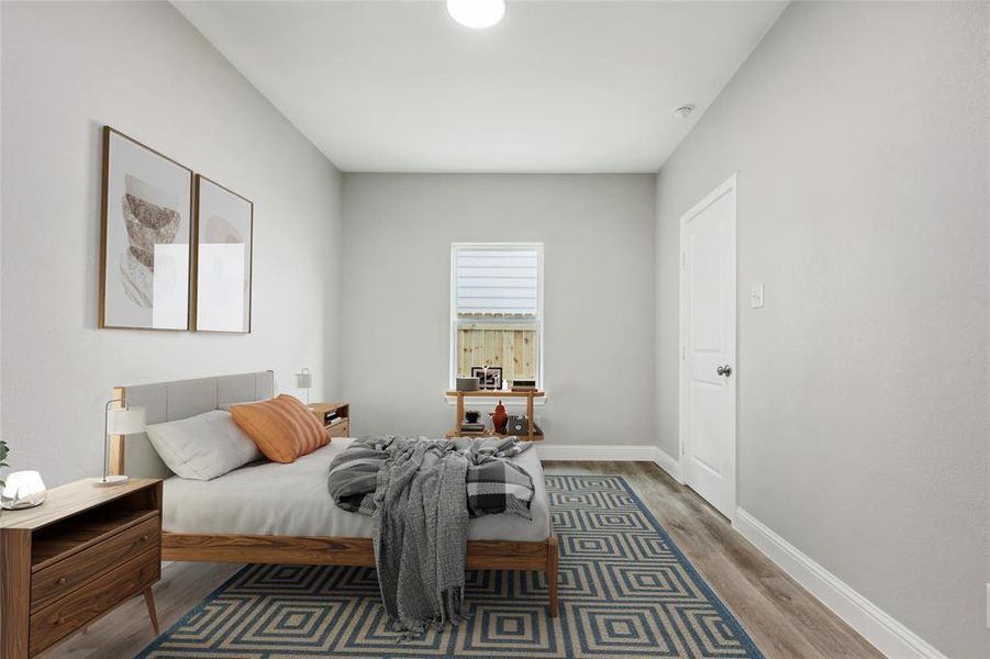 Bedroom with hardwood / wood-style flooring